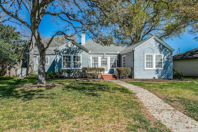 single story home featuring a front lawn