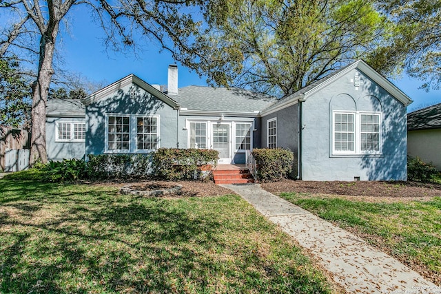 single story home featuring a front lawn