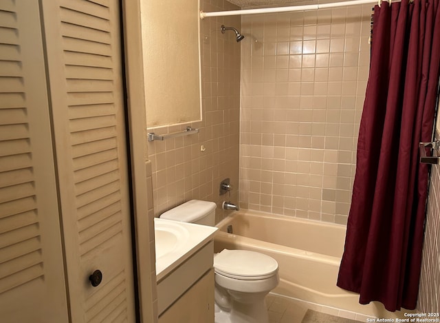 full bathroom featuring vanity, tile walls, toilet, and shower / bath combo with shower curtain