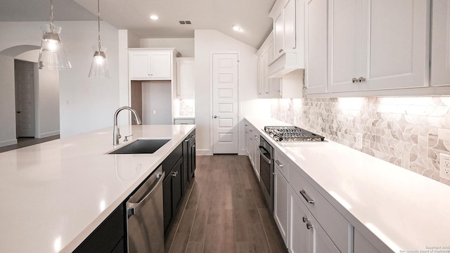 kitchen with decorative backsplash, light countertops, visible vents, appliances with stainless steel finishes, and a sink