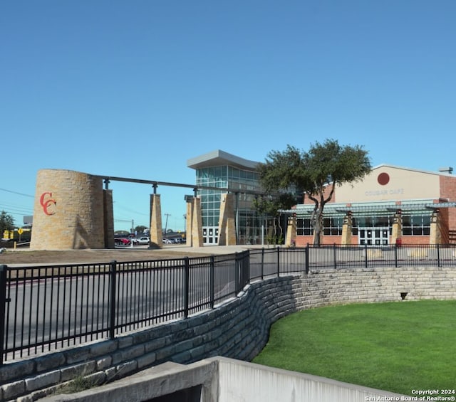 surrounding community featuring fence and a yard