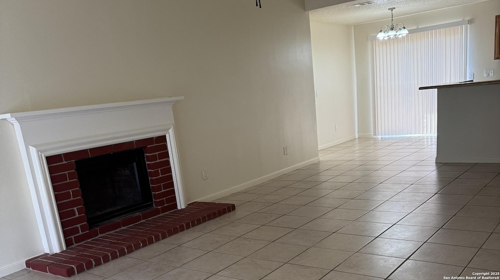 unfurnished living room featuring a notable chandelier, a fireplace, a textured ceiling, and light tile patterned floors