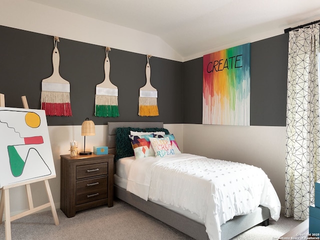 bedroom featuring lofted ceiling and light colored carpet