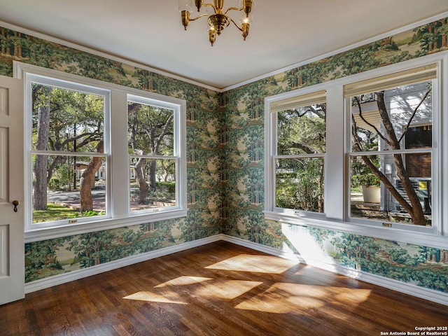 unfurnished sunroom featuring an inviting chandelier and a healthy amount of sunlight