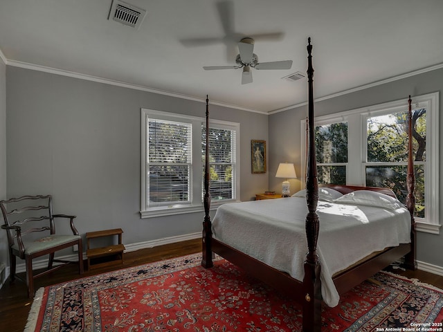 bedroom with crown molding, dark hardwood / wood-style flooring, and multiple windows