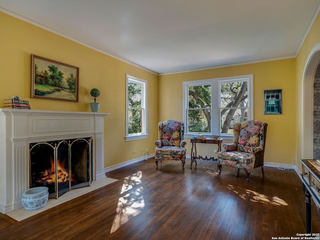 sitting room with crown molding and hardwood / wood-style floors