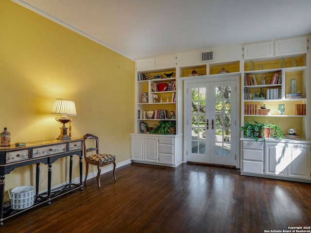 doorway to outside with crown molding, dark wood-type flooring, and french doors