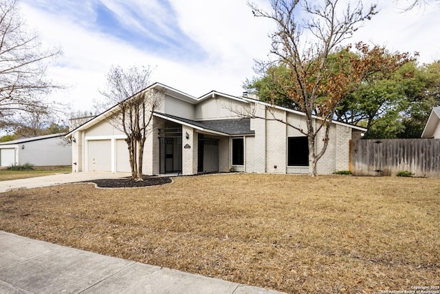 view of front of home with a garage and a front yard