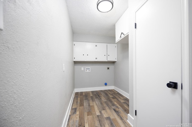 laundry area with cabinets, a textured ceiling, dark hardwood / wood-style flooring, hookup for a washing machine, and hookup for an electric dryer