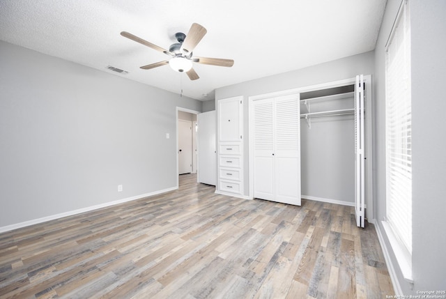 unfurnished bedroom with a closet, ceiling fan, and light hardwood / wood-style flooring