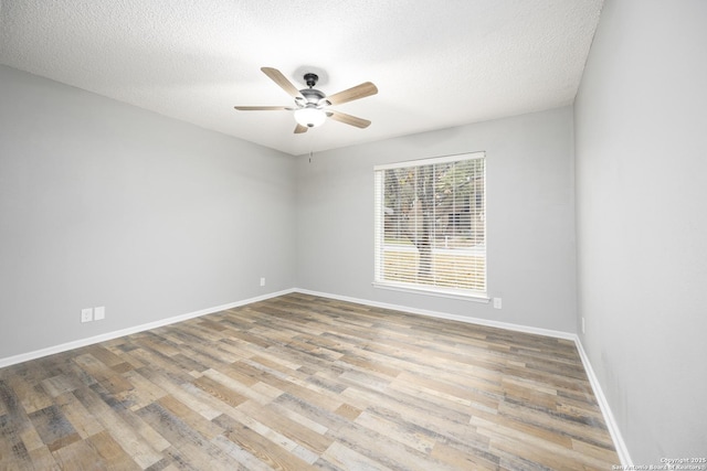 unfurnished room featuring a textured ceiling, light hardwood / wood-style floors, and ceiling fan