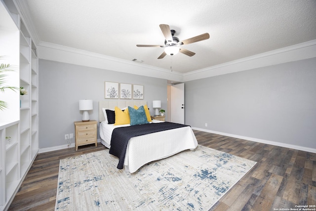 bedroom featuring dark hardwood / wood-style flooring, ceiling fan, ornamental molding, and a textured ceiling