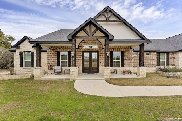 view of front of house with french doors and a front lawn