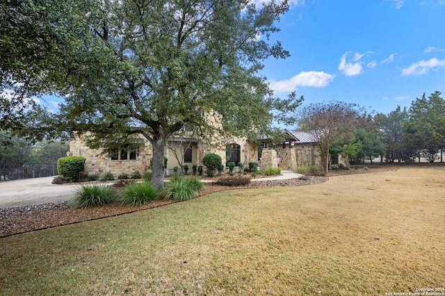 view of front of property featuring a front yard and stone siding