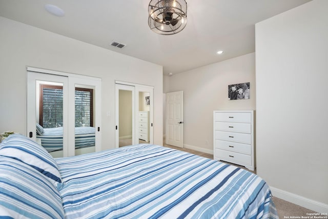 carpeted bedroom with recessed lighting, visible vents, and baseboards