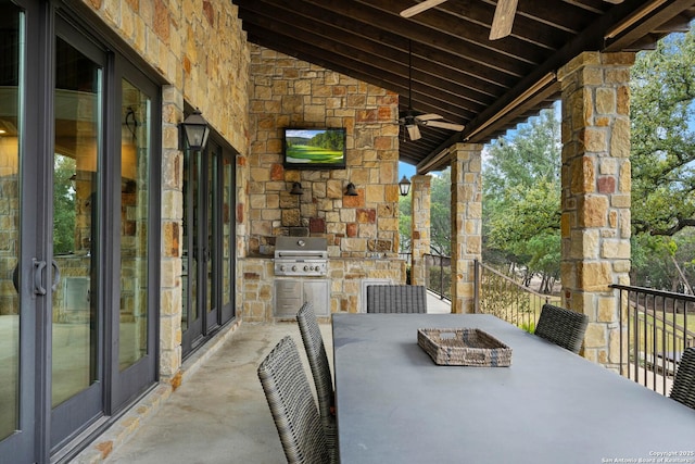 view of patio featuring exterior kitchen, outdoor dining area, and a grill