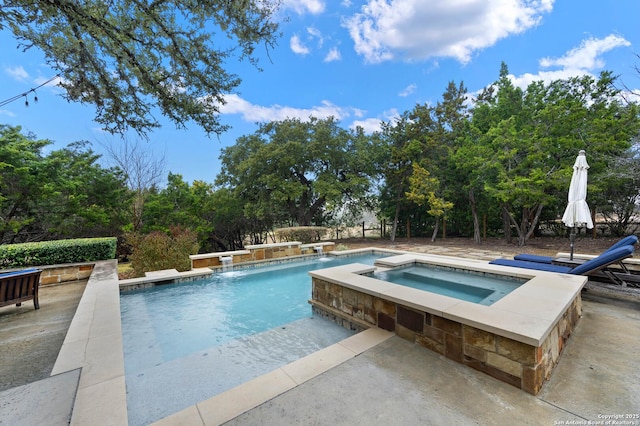 pool with a patio and an in ground hot tub