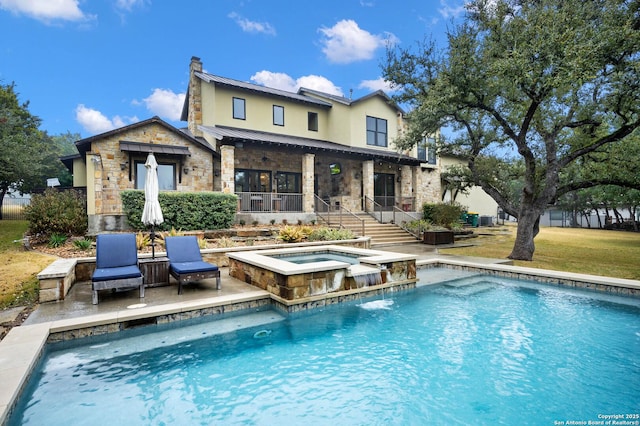 back of property with stone siding, a chimney, metal roof, a standing seam roof, and stucco siding