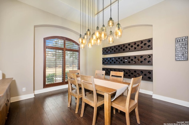 dining room with dark wood-style flooring and baseboards