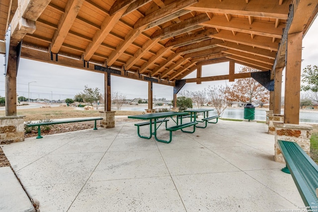 surrounding community with a gazebo and a water view