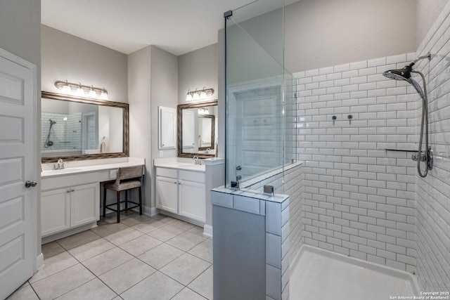 bathroom featuring vanity, tile patterned floors, and tiled shower