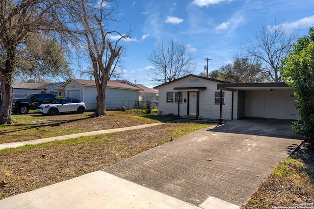 ranch-style house with a carport, a garage, and a front lawn