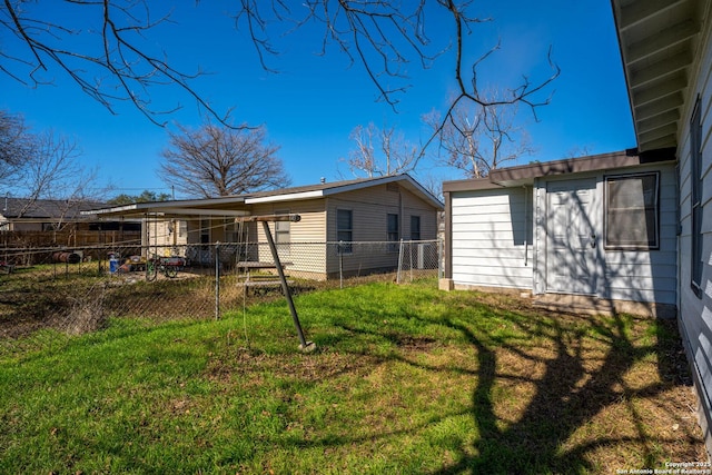 rear view of property with a lawn