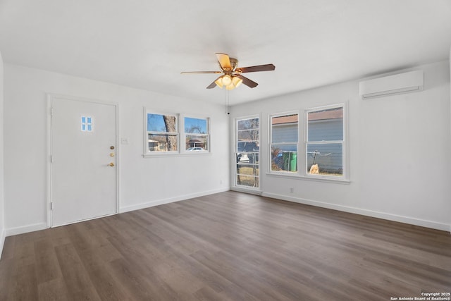 interior space with a wall unit AC, dark hardwood / wood-style floors, and ceiling fan