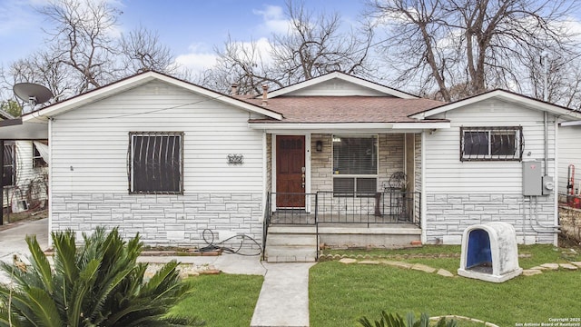 bungalow-style home with a front yard and a porch