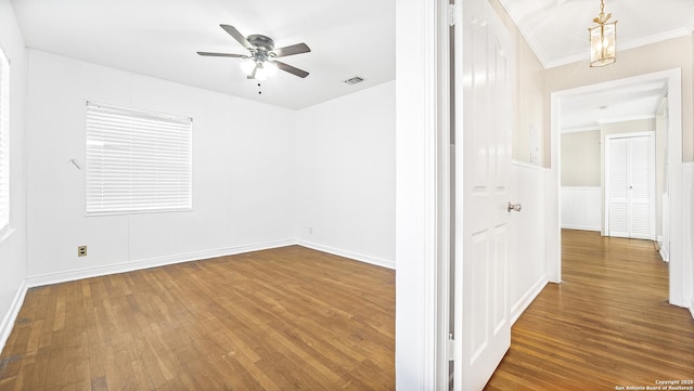 spare room with crown molding, hardwood / wood-style floors, and ceiling fan