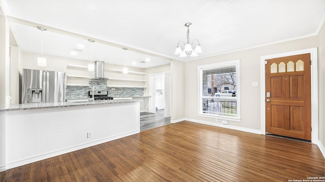 interior space with crown molding, dark hardwood / wood-style floors, sink, and an inviting chandelier