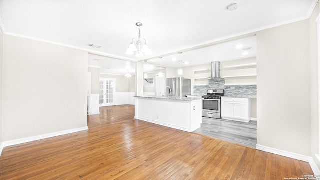 kitchen featuring pendant lighting, white cabinetry, ornamental molding, light hardwood / wood-style floors, and stainless steel appliances