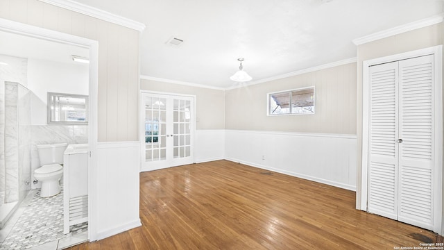 interior space featuring french doors, crown molding, and hardwood / wood-style floors