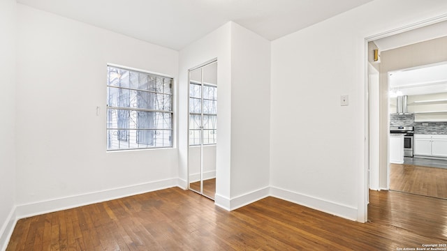 spare room with dark hardwood / wood-style flooring