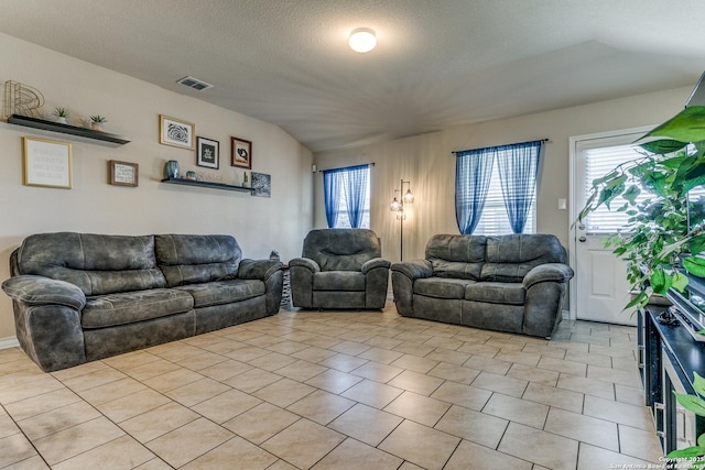 tiled living room featuring a textured ceiling