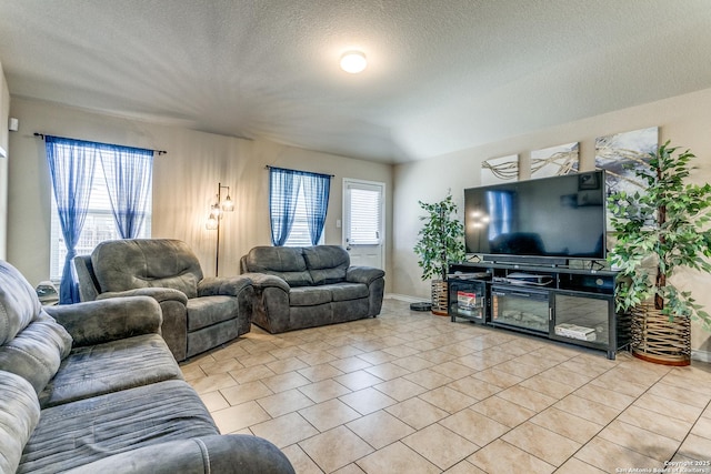 living room featuring light tile patterned flooring and a textured ceiling