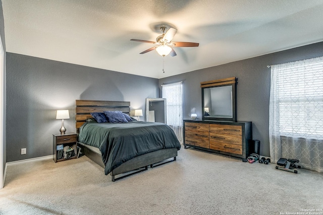 bedroom featuring carpet floors, a textured ceiling, and ceiling fan