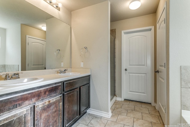 bathroom with vanity, a shower with shower door, and tile patterned flooring