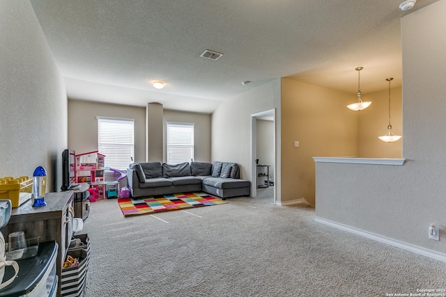 carpeted living room with a textured ceiling