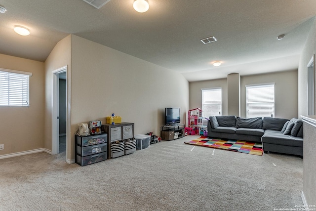 carpeted living room with lofted ceiling