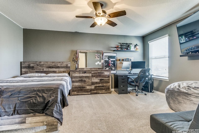 carpeted bedroom with a textured ceiling and ceiling fan