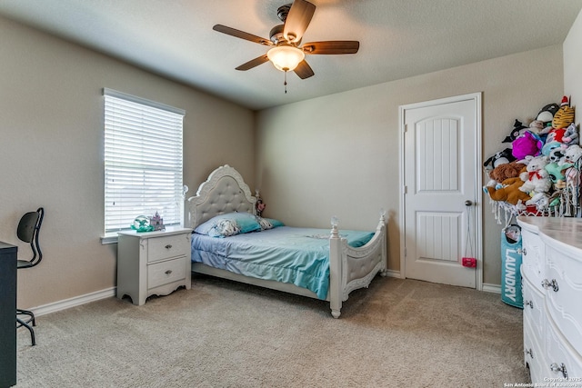 bedroom featuring light colored carpet and ceiling fan