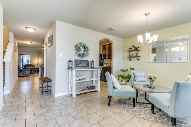 interior space with light tile patterned floors and a chandelier