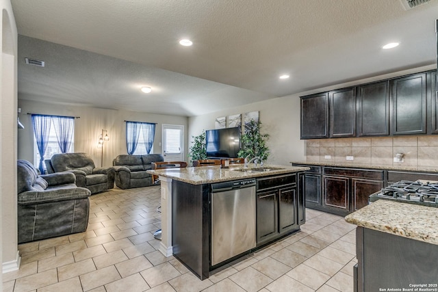 kitchen with sink, a wealth of natural light, dishwasher, and a center island with sink