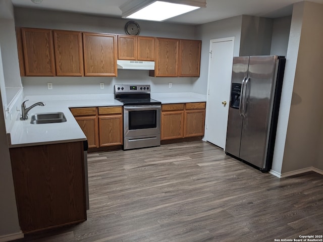 kitchen featuring hardwood / wood-style flooring, appliances with stainless steel finishes, and sink