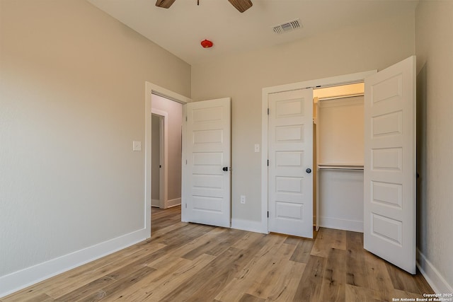 unfurnished bedroom with a closet and light wood-type flooring