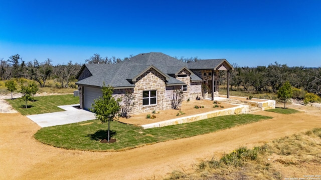 view of front of property with a garage and a front lawn