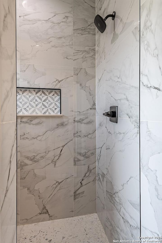 bathroom with a tile shower