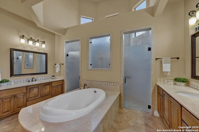 bathroom with independent shower and bath, vanity, and tile patterned floors