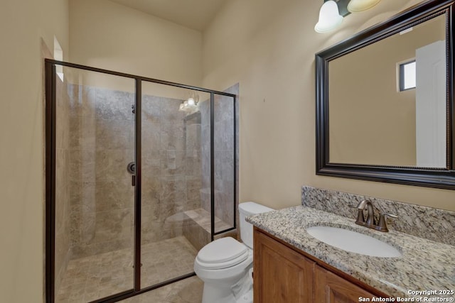 bathroom featuring walk in shower, vanity, and toilet